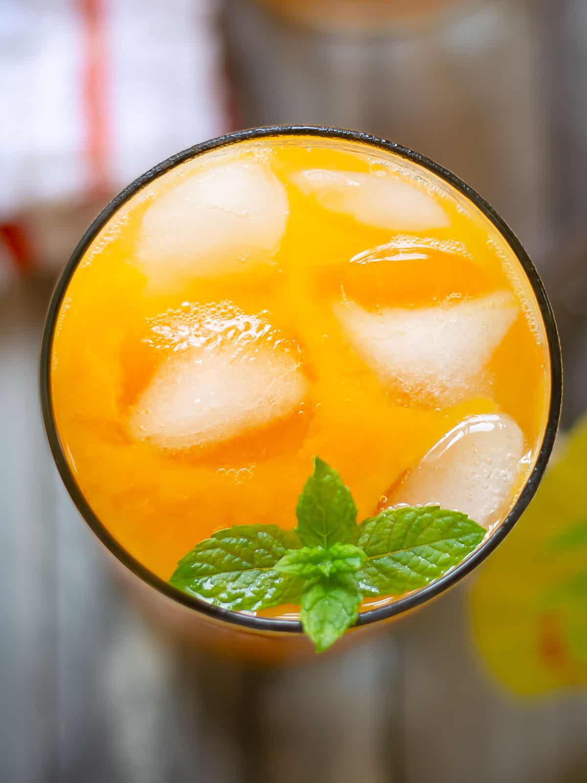 fresh mango juice with ice cubes and mint leaves