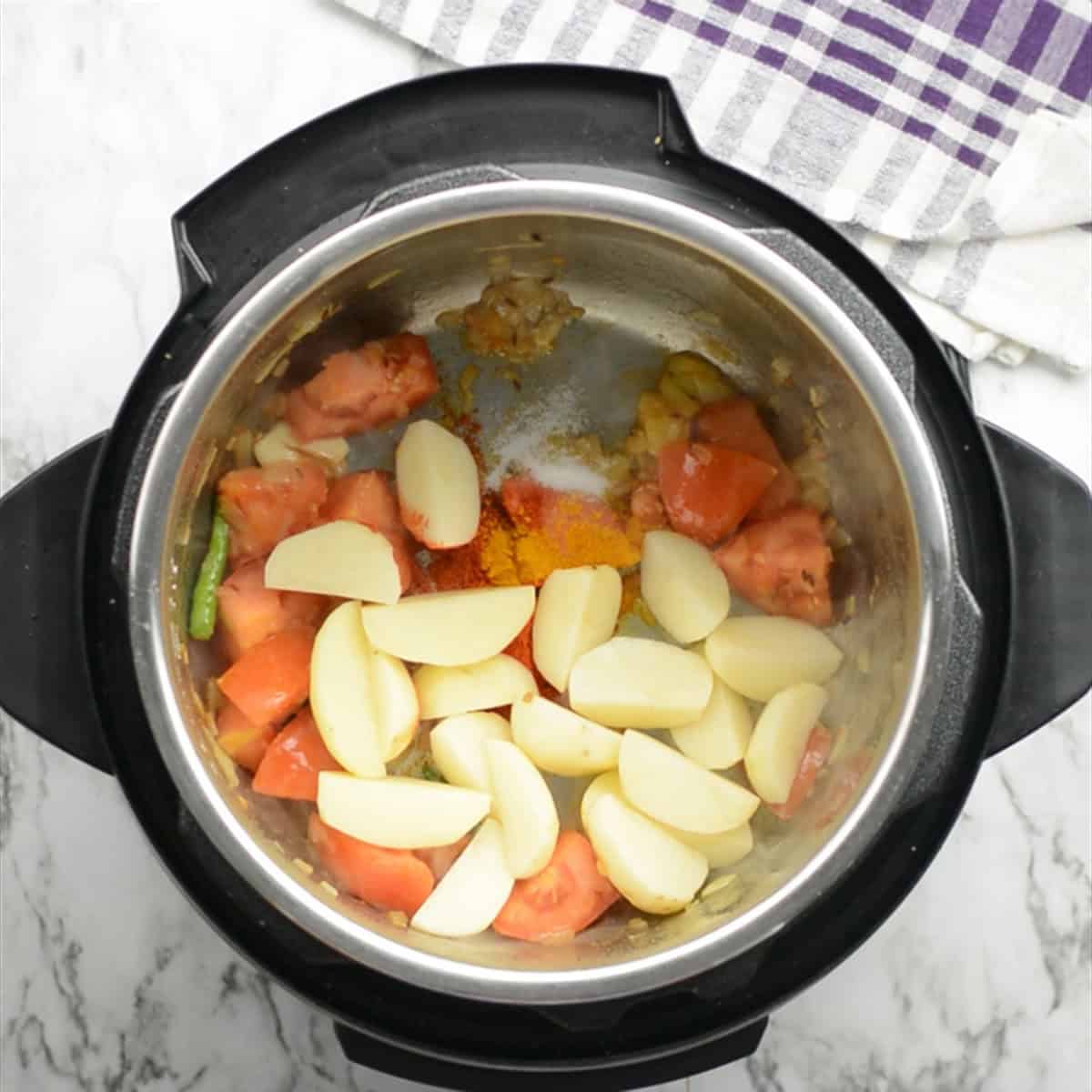 potato cubes added to make potato curry with spices
