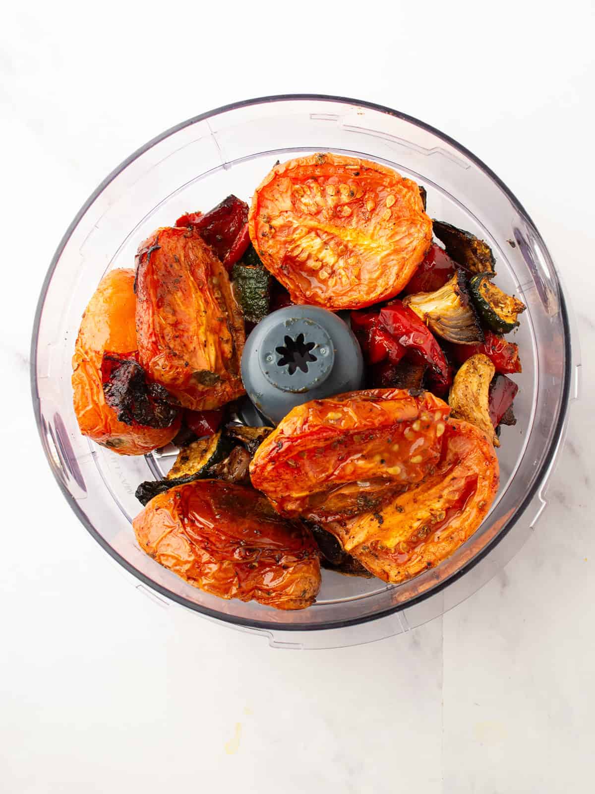 Adding the roasted vegetables to a blender