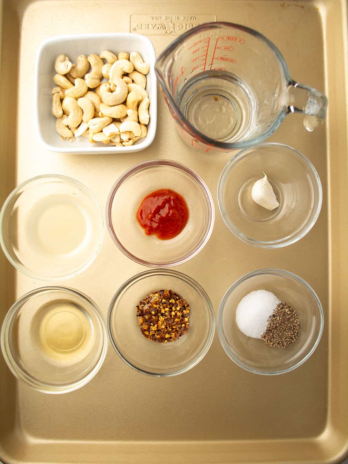 Ingredients for Spicy Cashew Dressing: cashews, lime juice, apple cider vinegar, sriracha, honey, garlic, and spices.