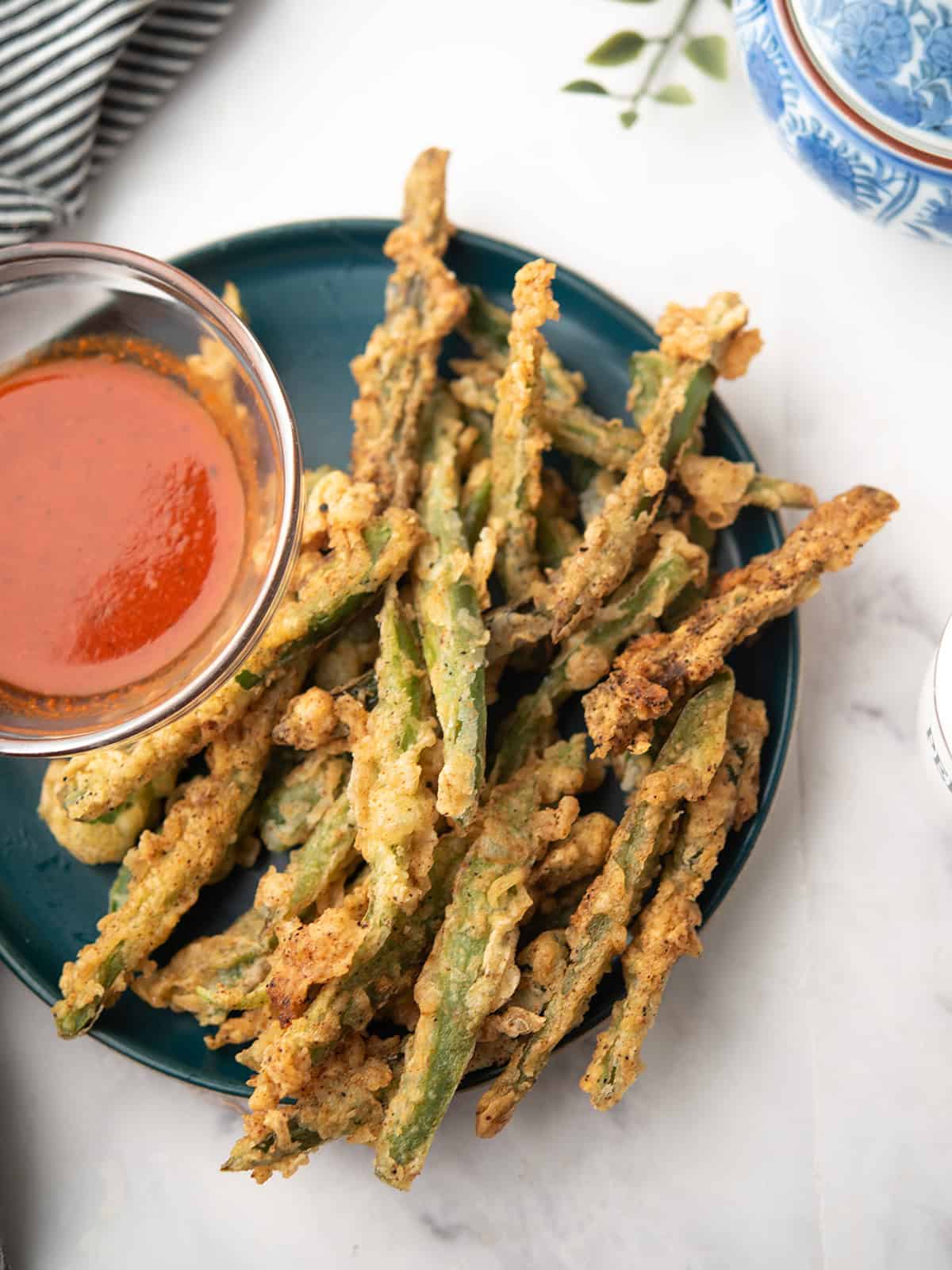 crispy Texas toothpickles served in a plate with the dipping sauce
