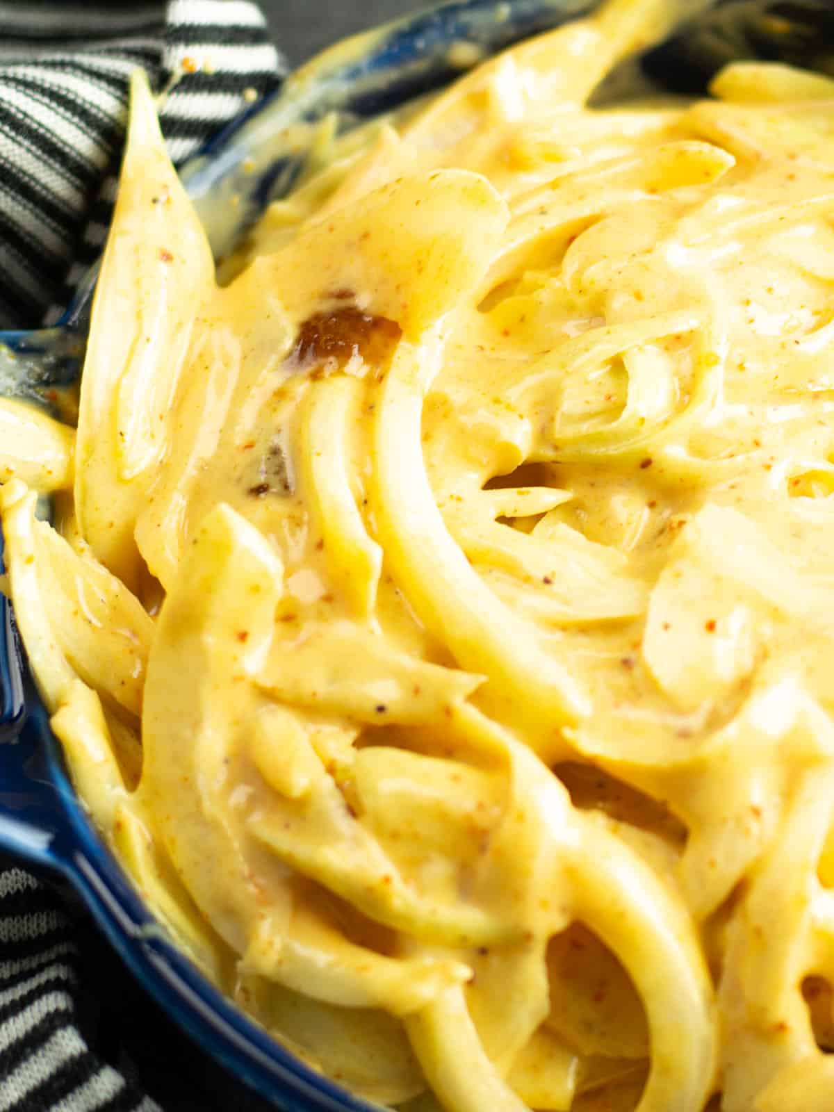 a closeup view of Cajun coleslaw with a creamy texture and spices as the garnish.