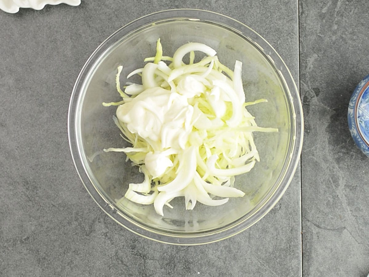 cabbage and mayo added to the pan