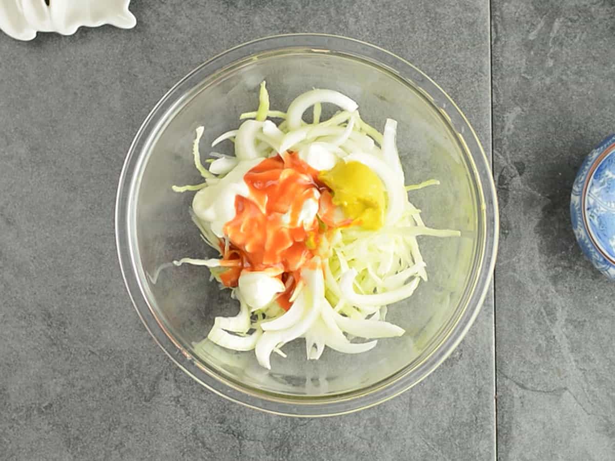hot sauce and mustard sauce added to the shredded cabbage