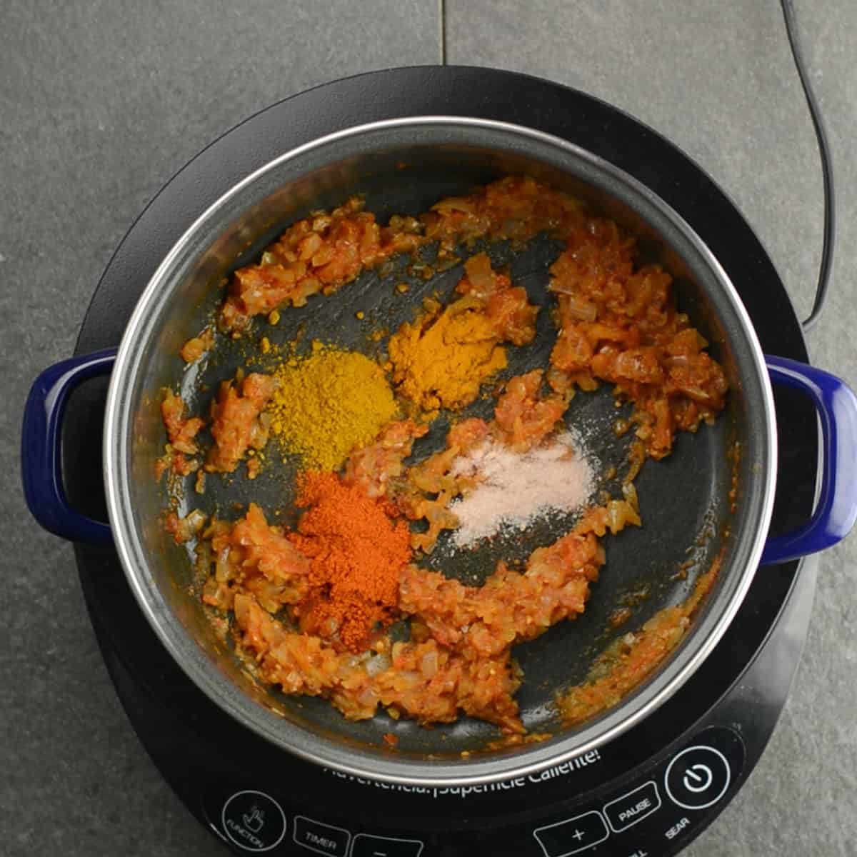 adding the spice powders to the curry