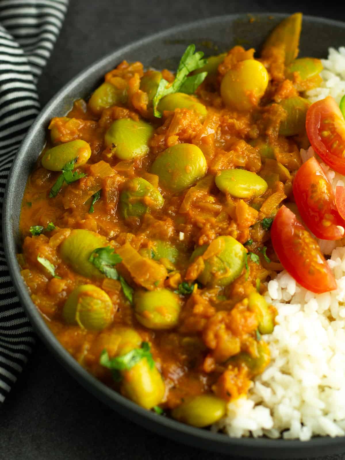 the close up view of the lima bean curry, with the onion tomato based sauce