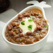madras lentils served in bowl, garnished with butter and cilantro.