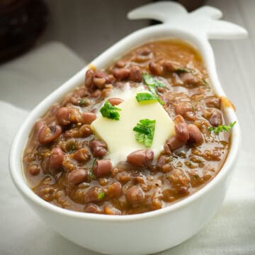 madras lentils served in bowl, garnished with butter and cilantro.