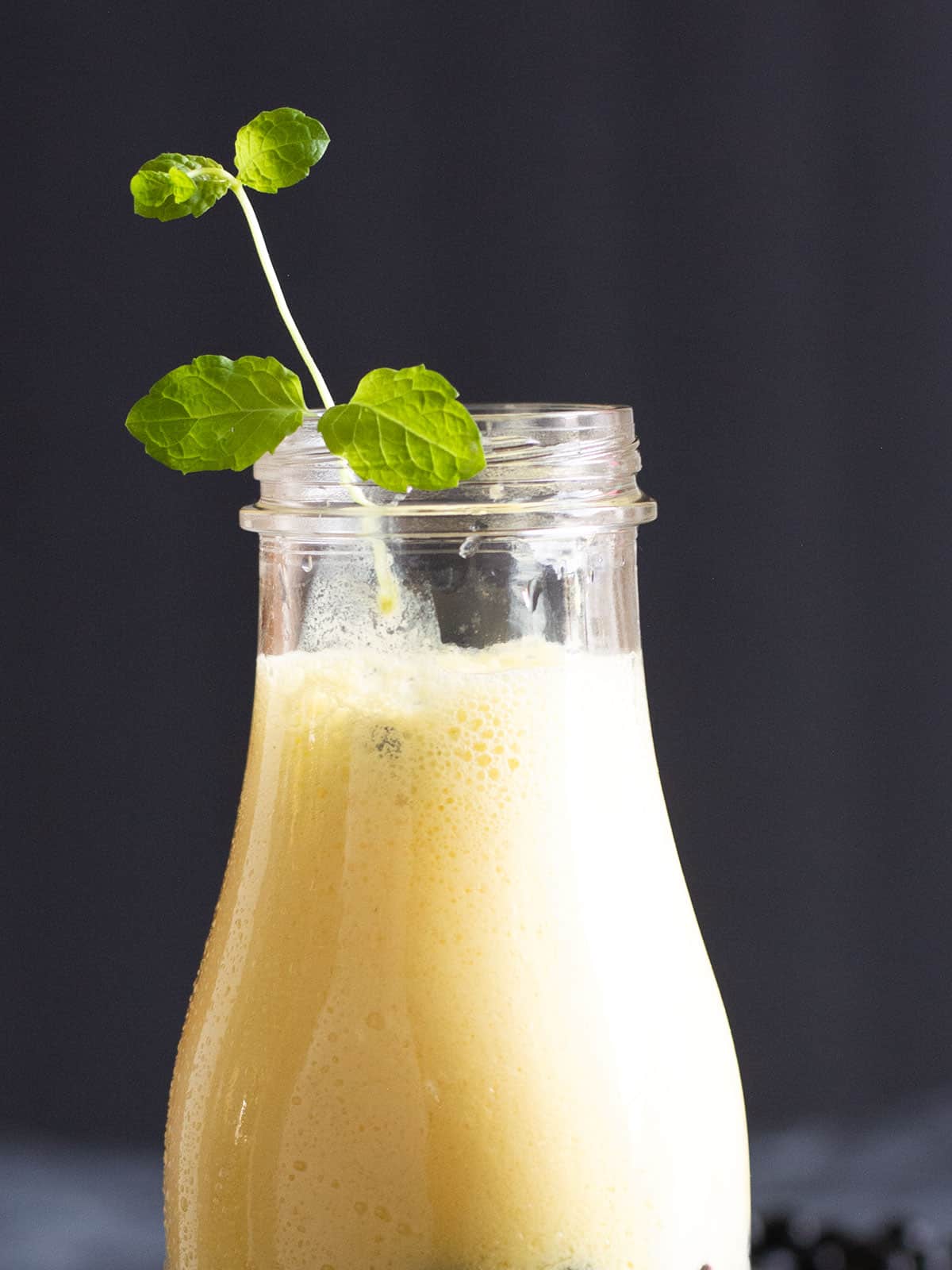 Close-up of Mango Boba Smoothie in a glass, showing tapioca pearls.