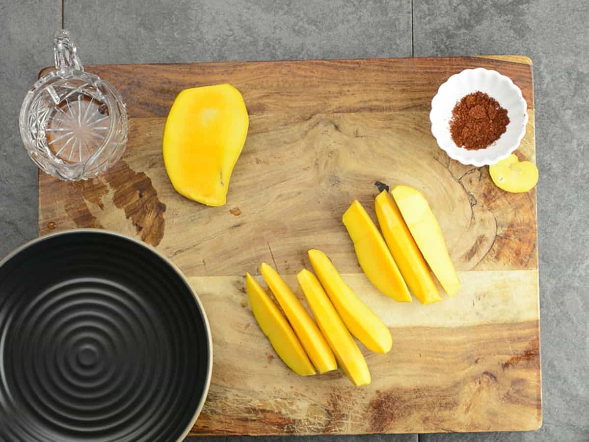 the ingredients of the mango with powder assembled in the cutting board