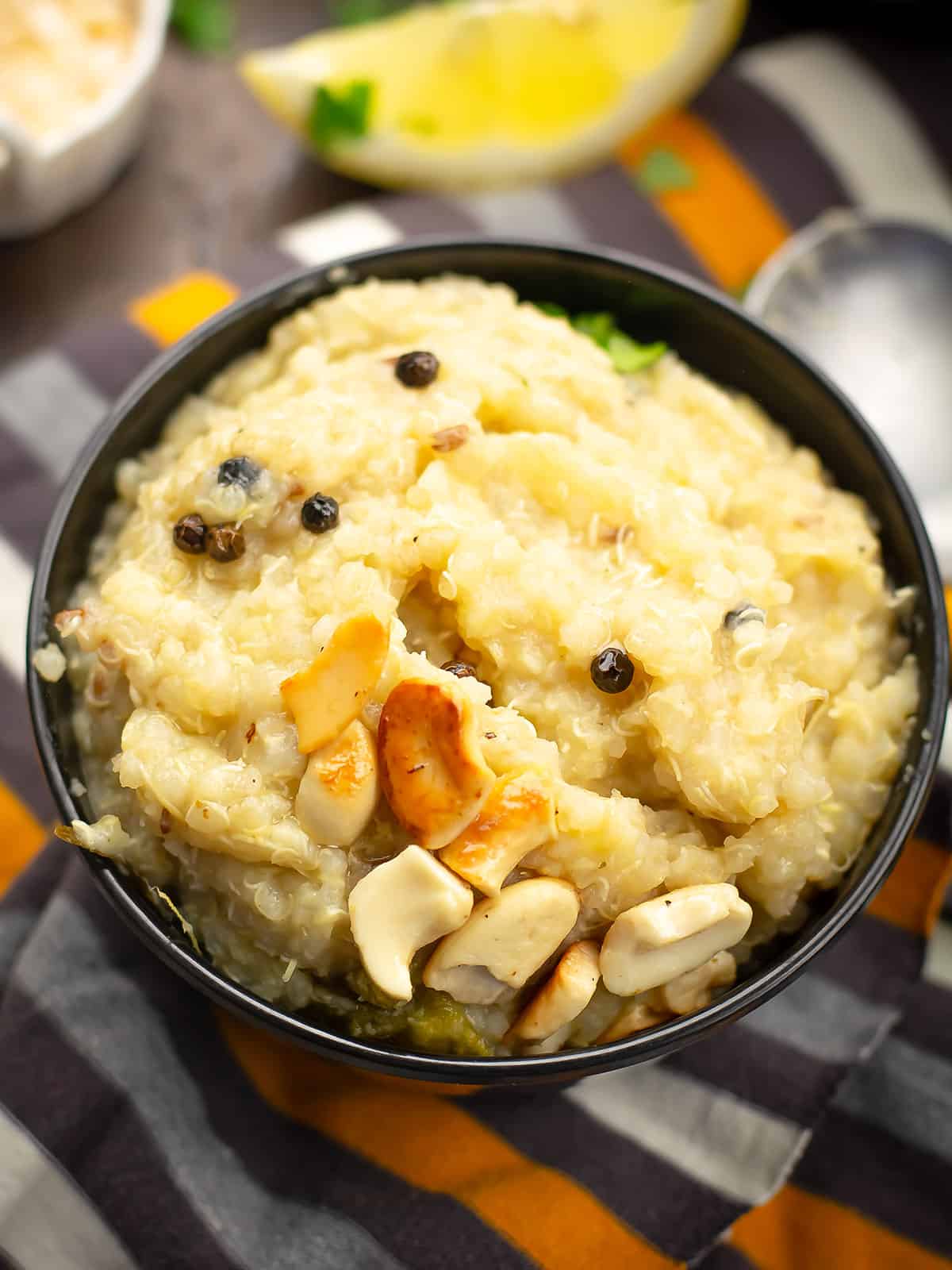 quinoa pongal served in a bowl with black pepper on the top