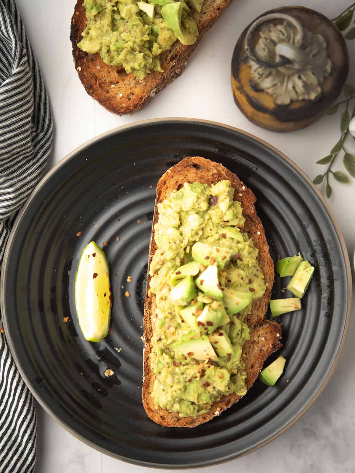 Delicious spicy avocado toast topped with jalapeños and hot sauce