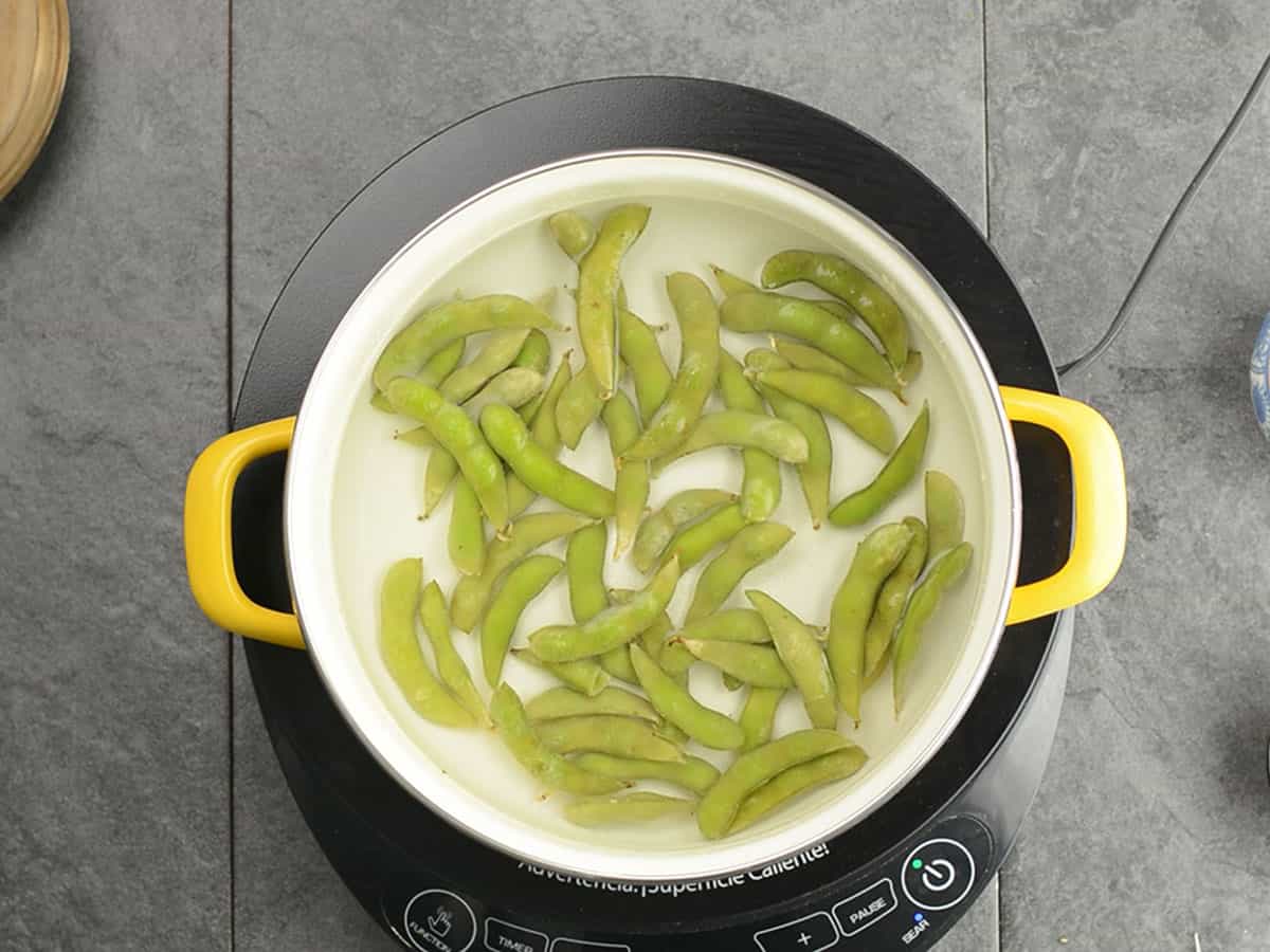 Cooking edamame in boiling water.