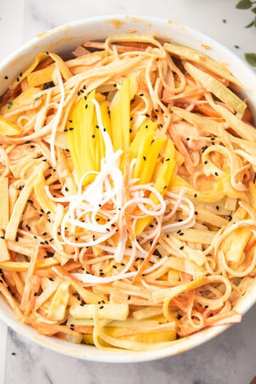 spicy kani salad served in a bowl with fork.