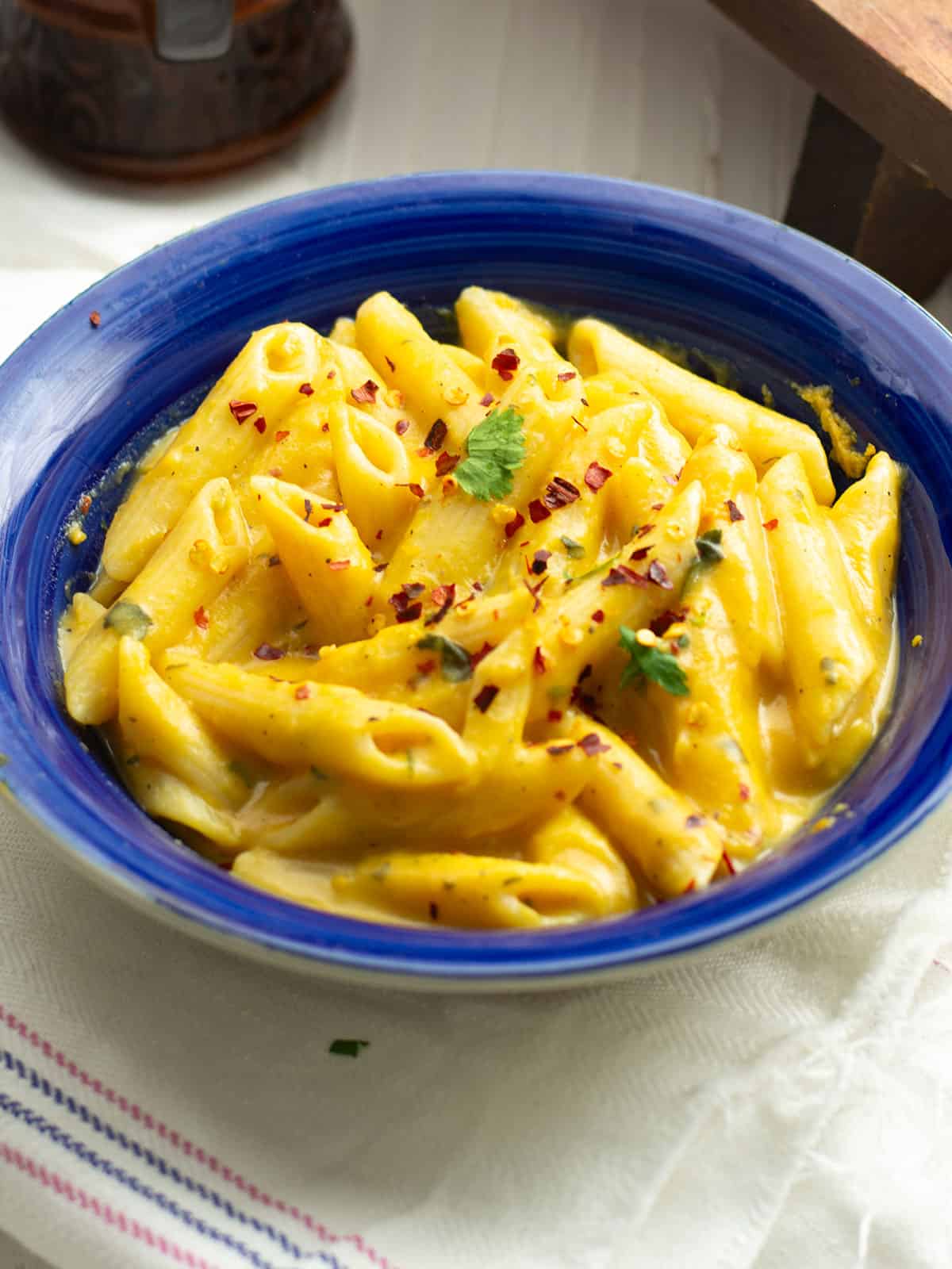 the creamy sweet potato pasta sauce in a blue colored bowl