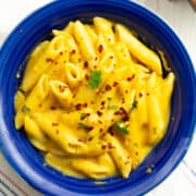 the creamy, sweet potato pasta sauce with the penne pasta, garnished with crushed red peppers and parsley.