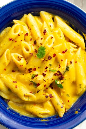 the creamy, sweet potato pasta sauce with the penne pasta, garnished with crushed red peppers and parsley.