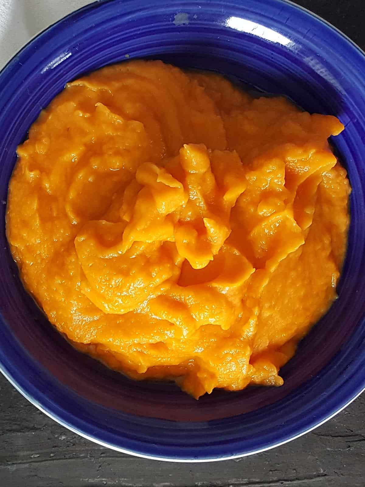 Blended sweet potato and tomato puree in a blender.