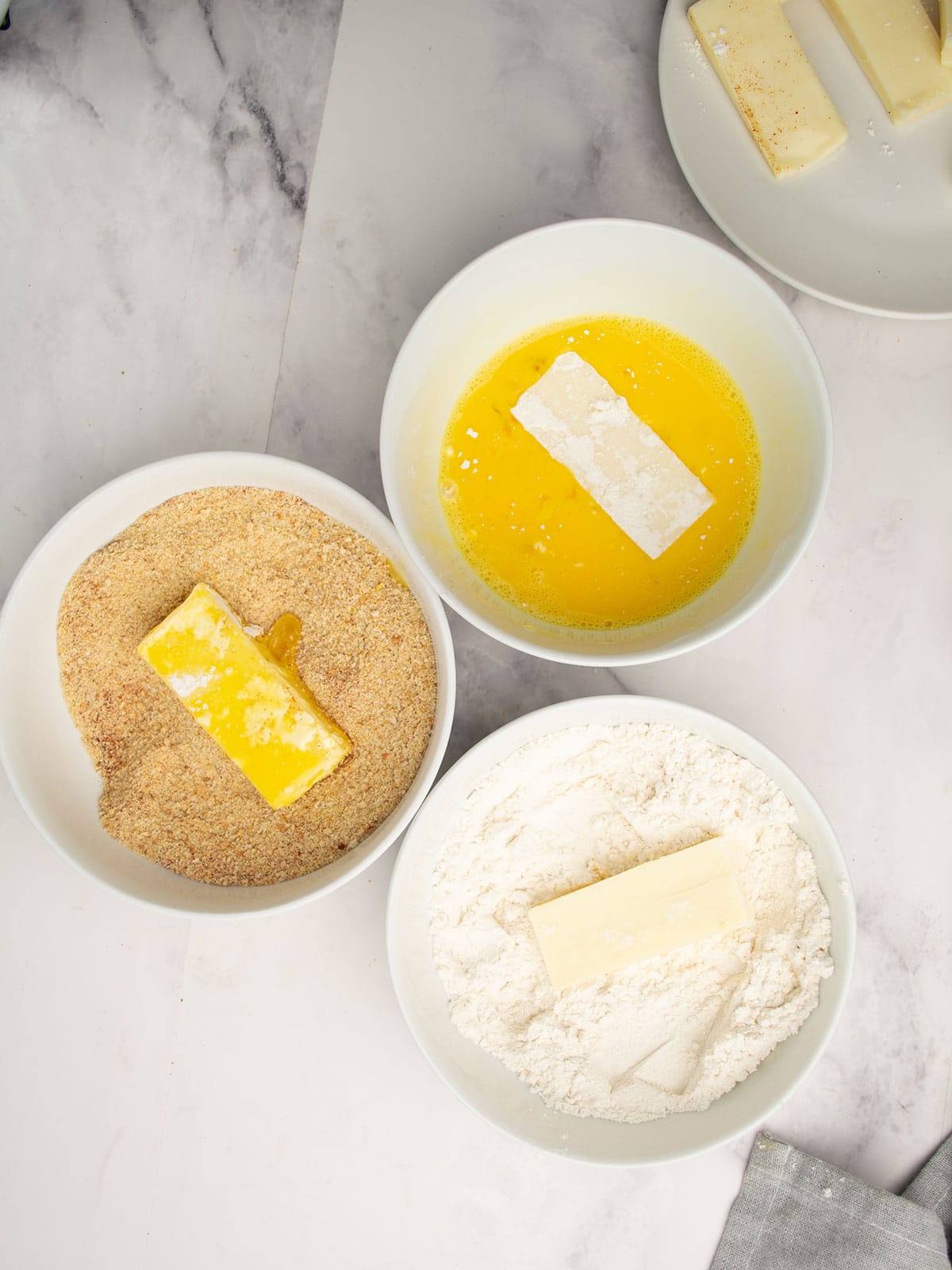 Bowls set for breading with flour, egg wash, and panko.