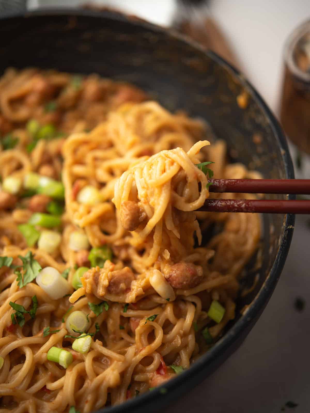 Close-up of colorful Chili Peanut Noodles with fresh cilantro garnish