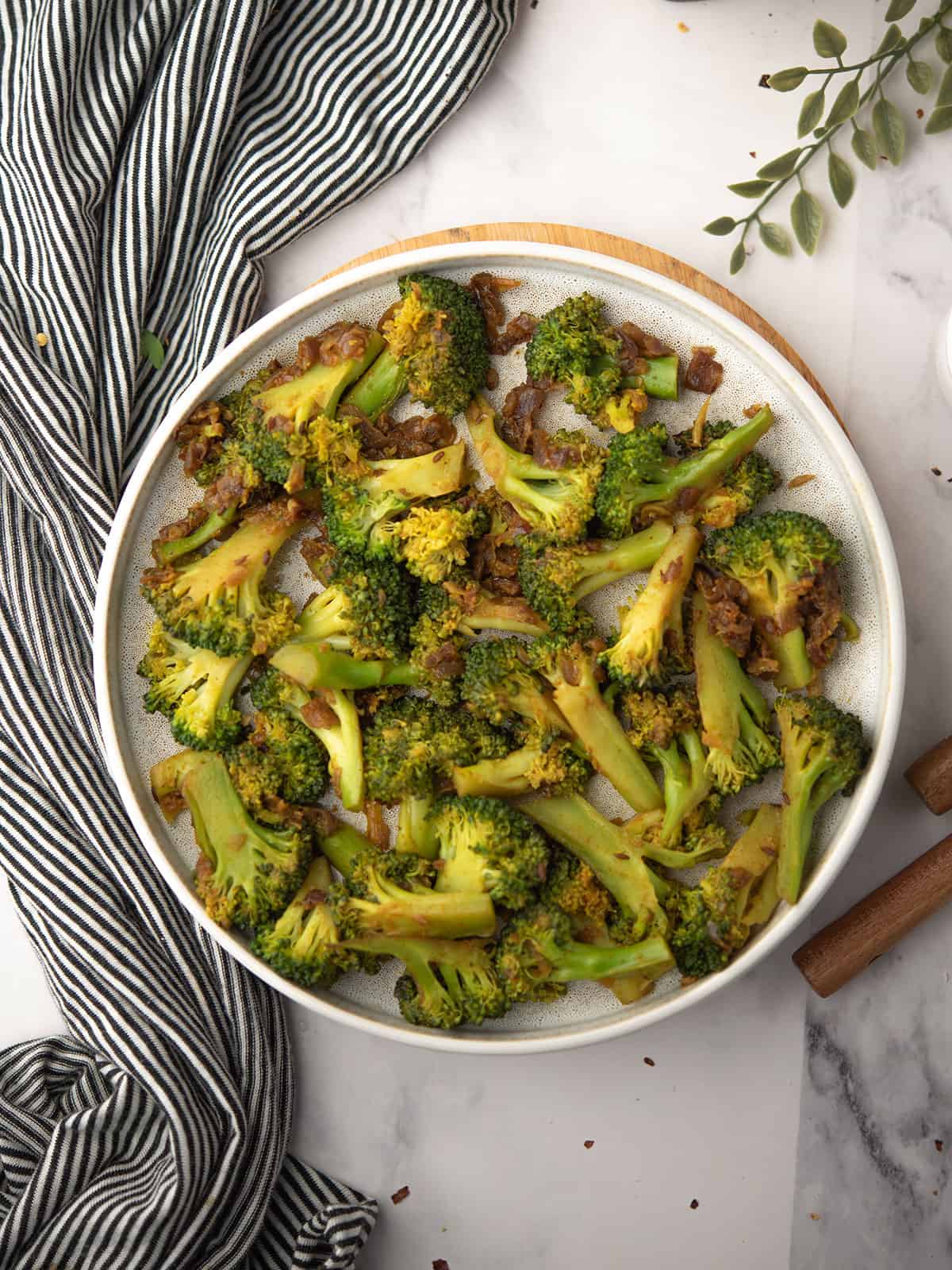 Delicious curried broccoli coated with spices served in a plate