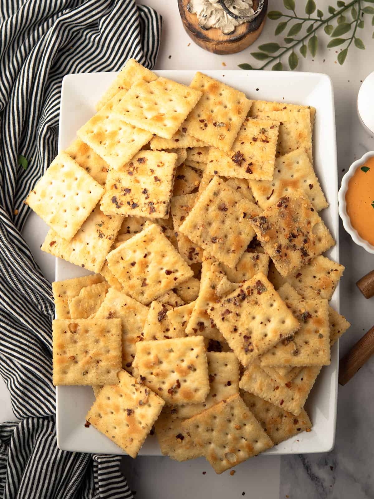 Bowl of spicy Saltine crackers topped with seasoning.