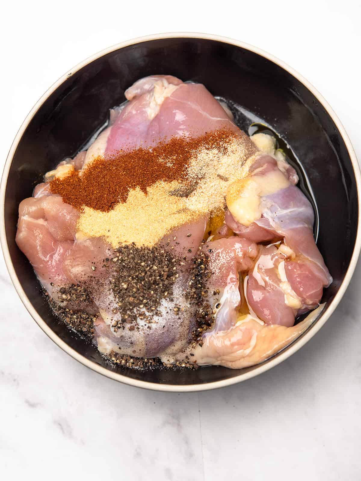 adding seasonings to the chicken