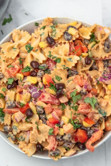 Chipotle pasta salad served with black beans, corn, and the cilantro as the garnish