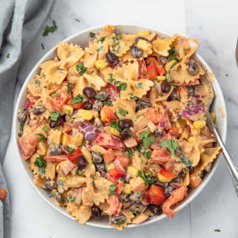 Chipotle pasta salad served with black beans, corn, and the cilantro as the garnish