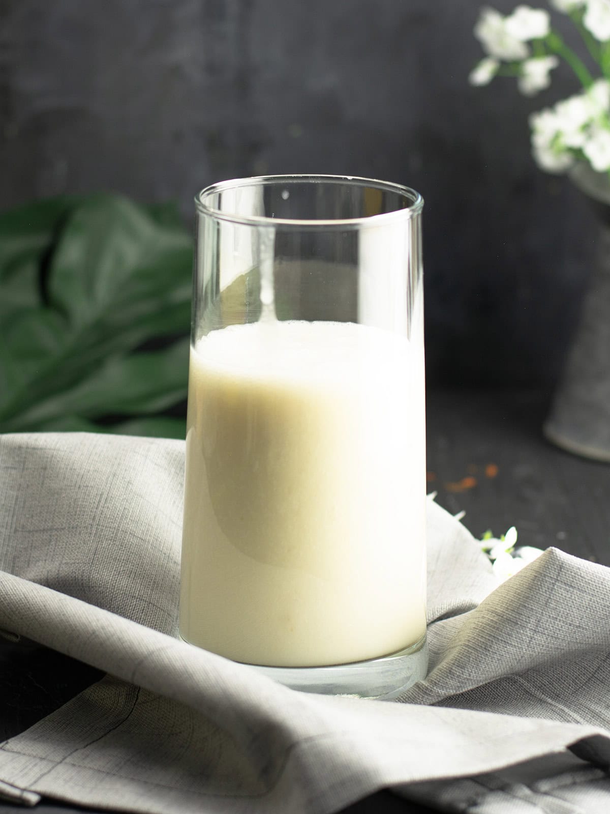 coconut milk banana smoothie, served in a tall glass over the breakfast table