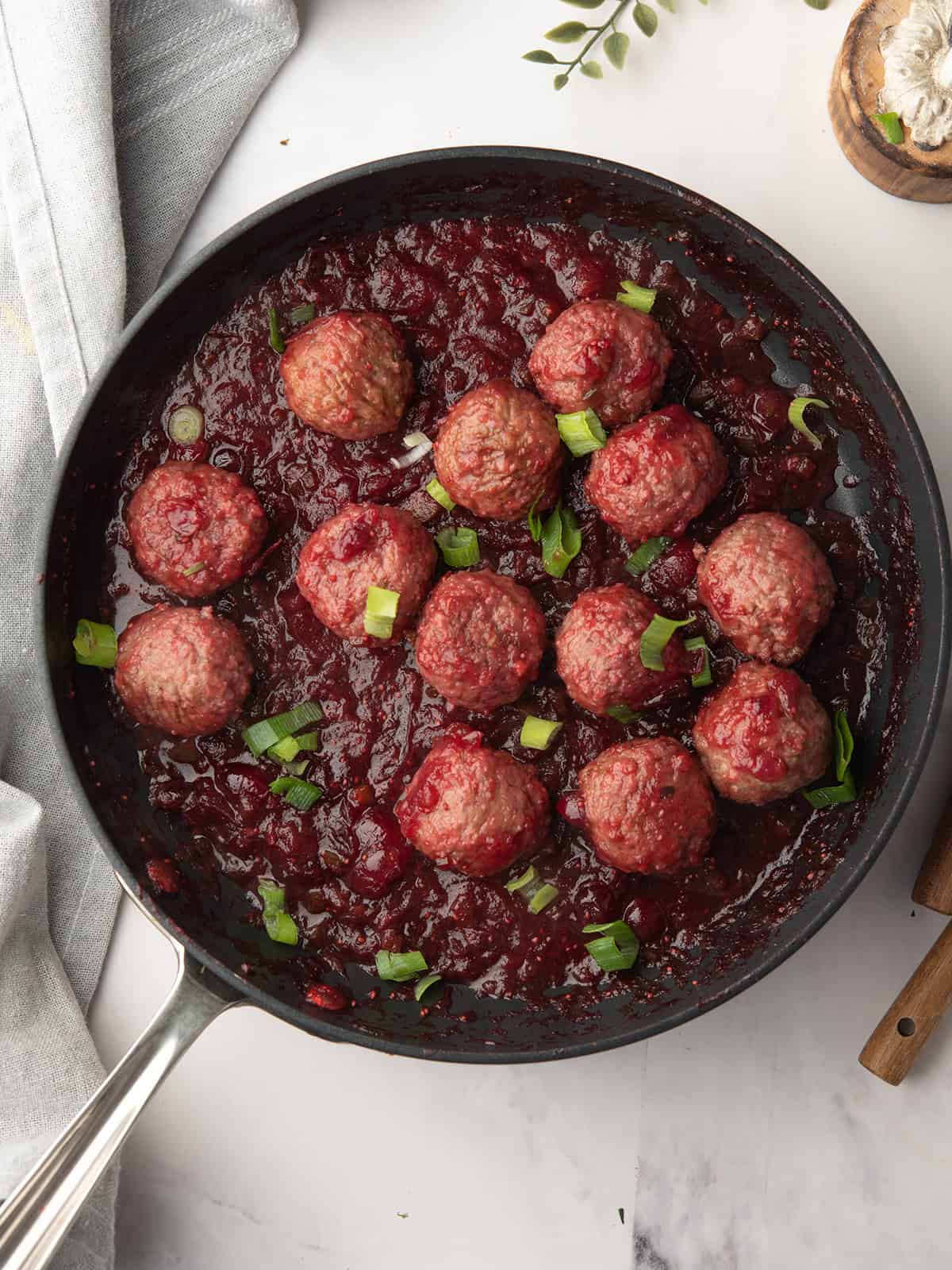 Delicious Jalapeño Cranberry Meatballs garnished with green onions.