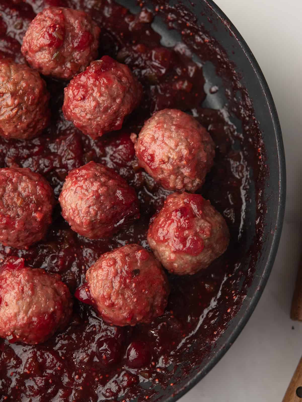 A close-up of Jalapeño Cranberry Meatballs on a serving platter.