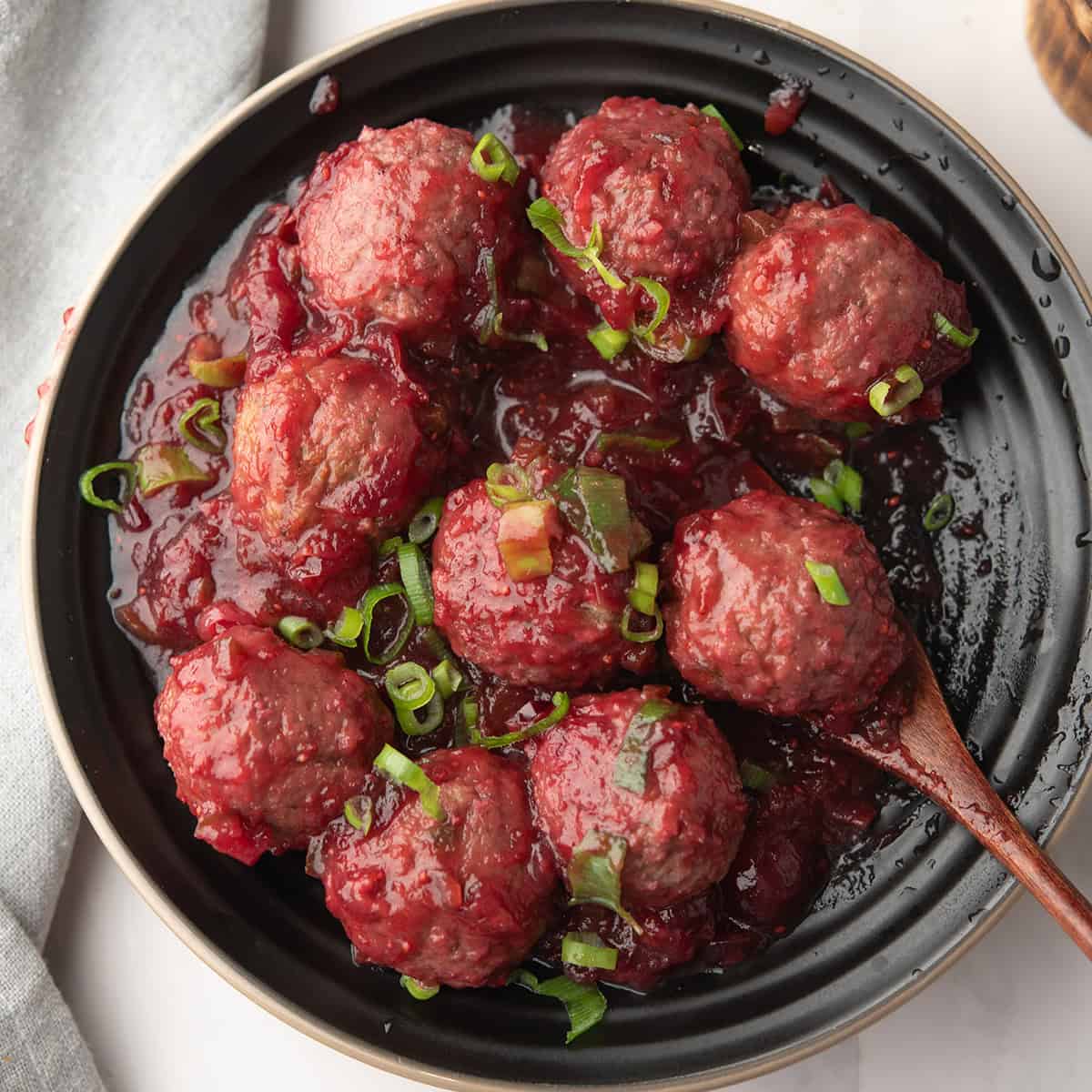 jalapeno cranberry sauce served in a plate with a spoon