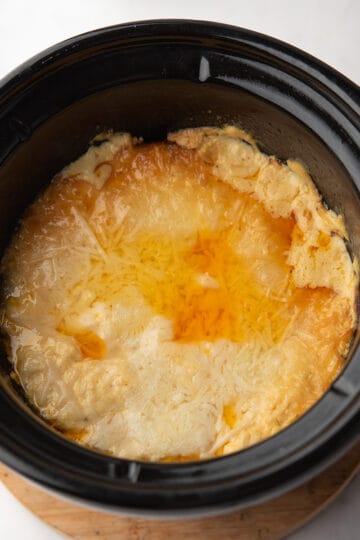 creamy Buffalo Crab Dip in the slow cooker ready to serve with tortilla chips.