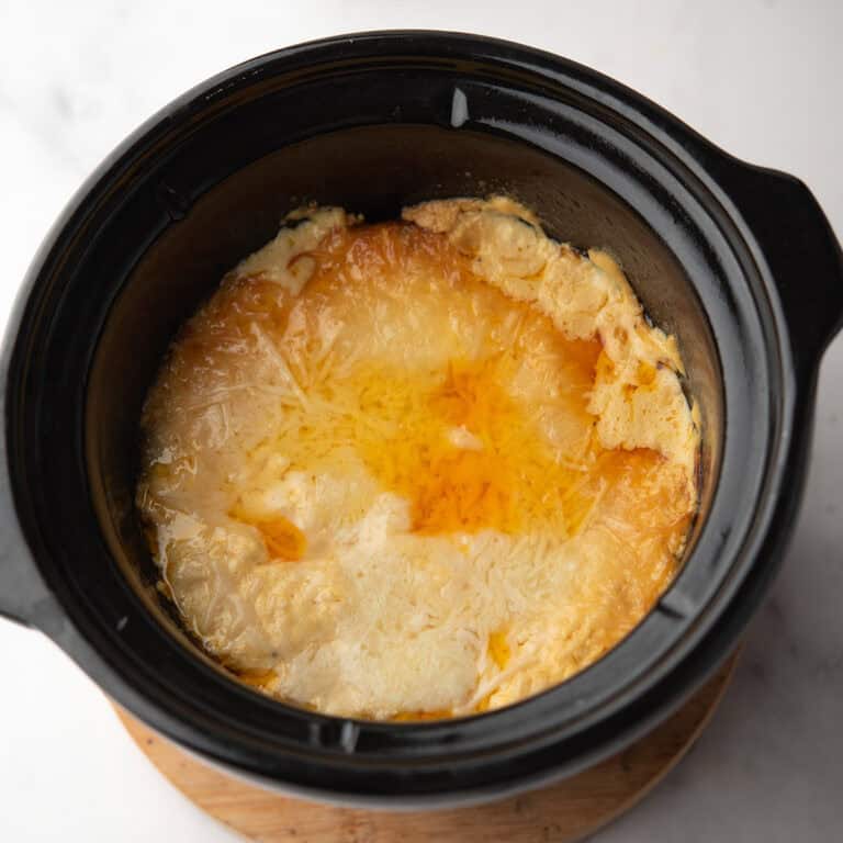 creamy Buffalo Crab Dip in the slow cooker ready to serve with tortilla chips.