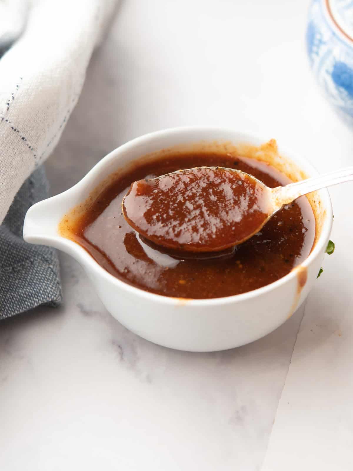 Homemade Pineapple BBQ Sauce in a jar with a spoon