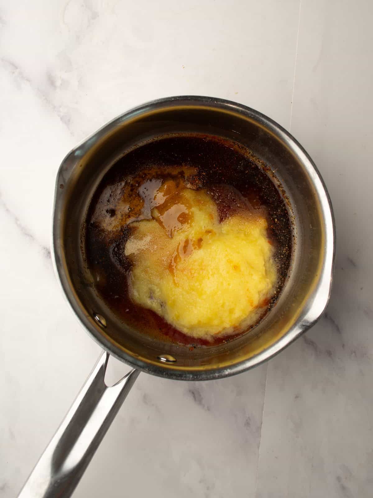 adding crushed pineapple to the pan