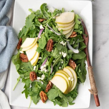 Arugula pear salad topped with goat cheese and candied walnuts.