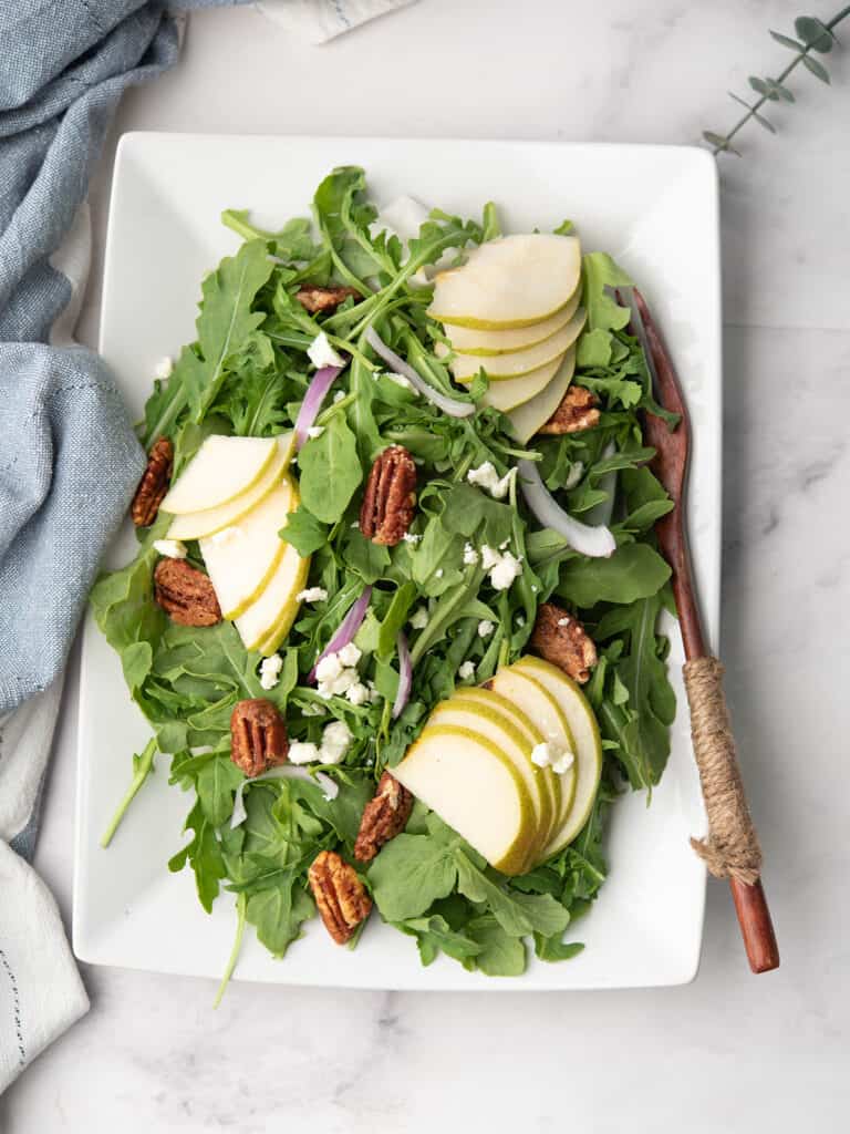 Arugula pear salad topped with goat cheese and candied walnuts.