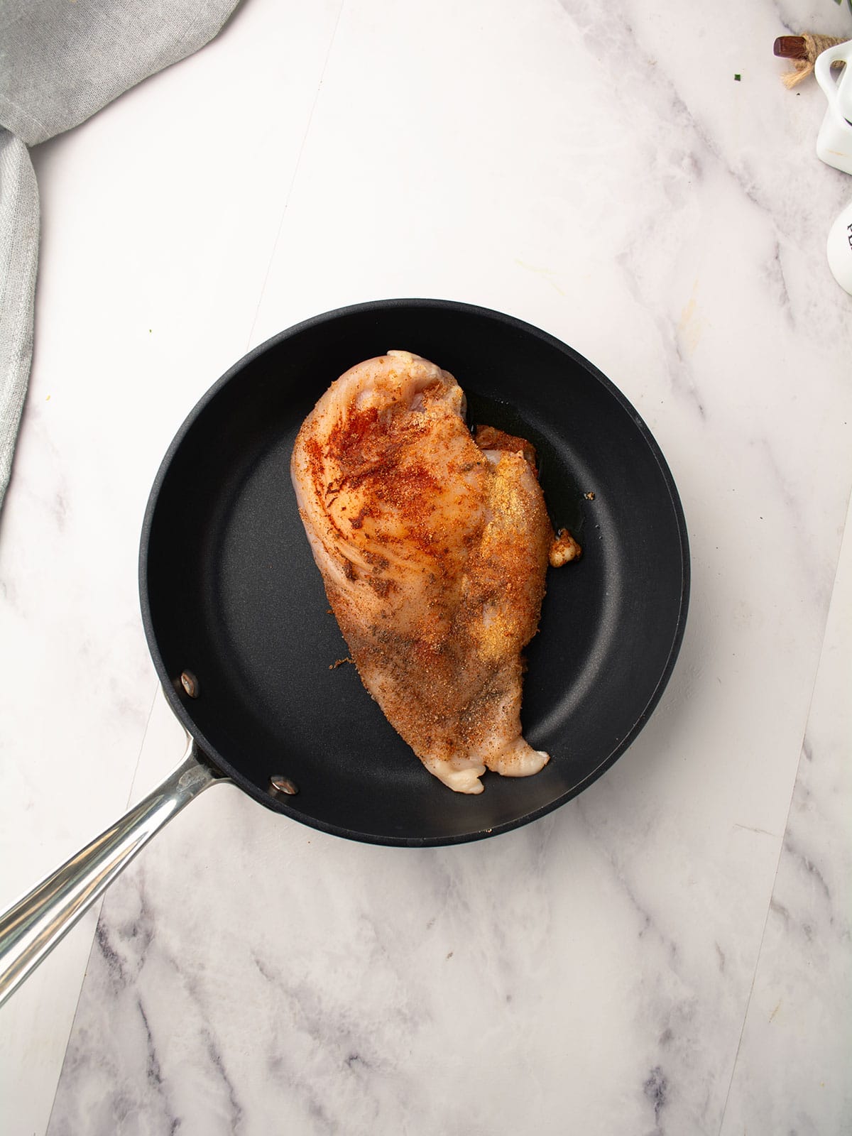 chicken seasoned with spices is cooking in a pan