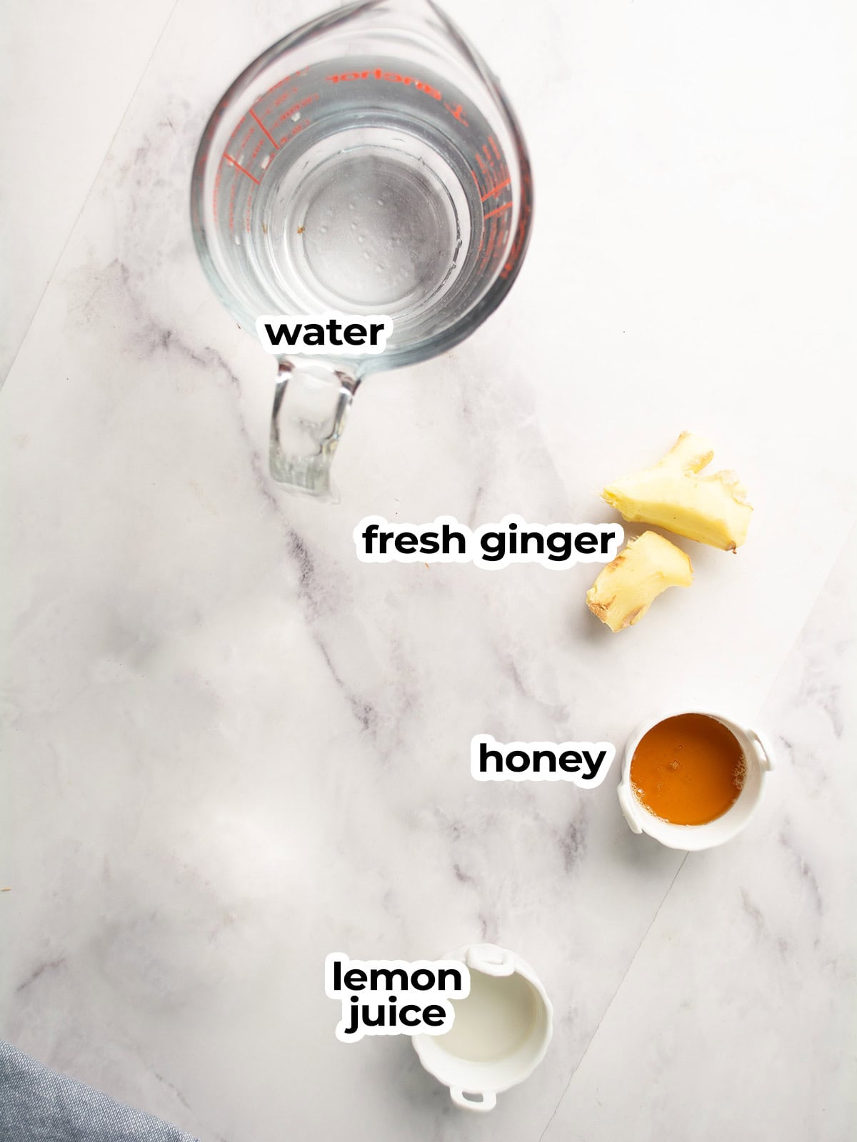 the ingredients for the ginger lemon honey tea assembled 
in the kitchen counter
