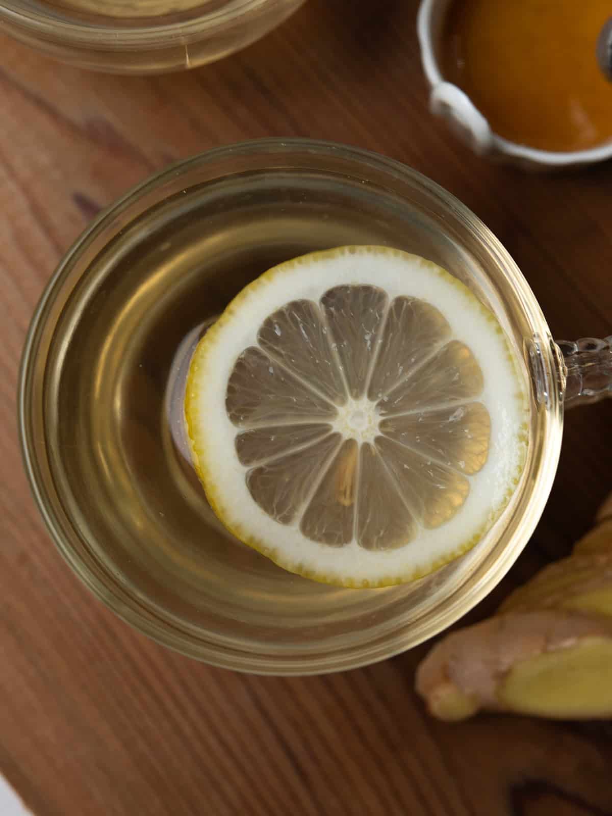 Refreshing ginger lemon honey tea served garnished with lemon slices