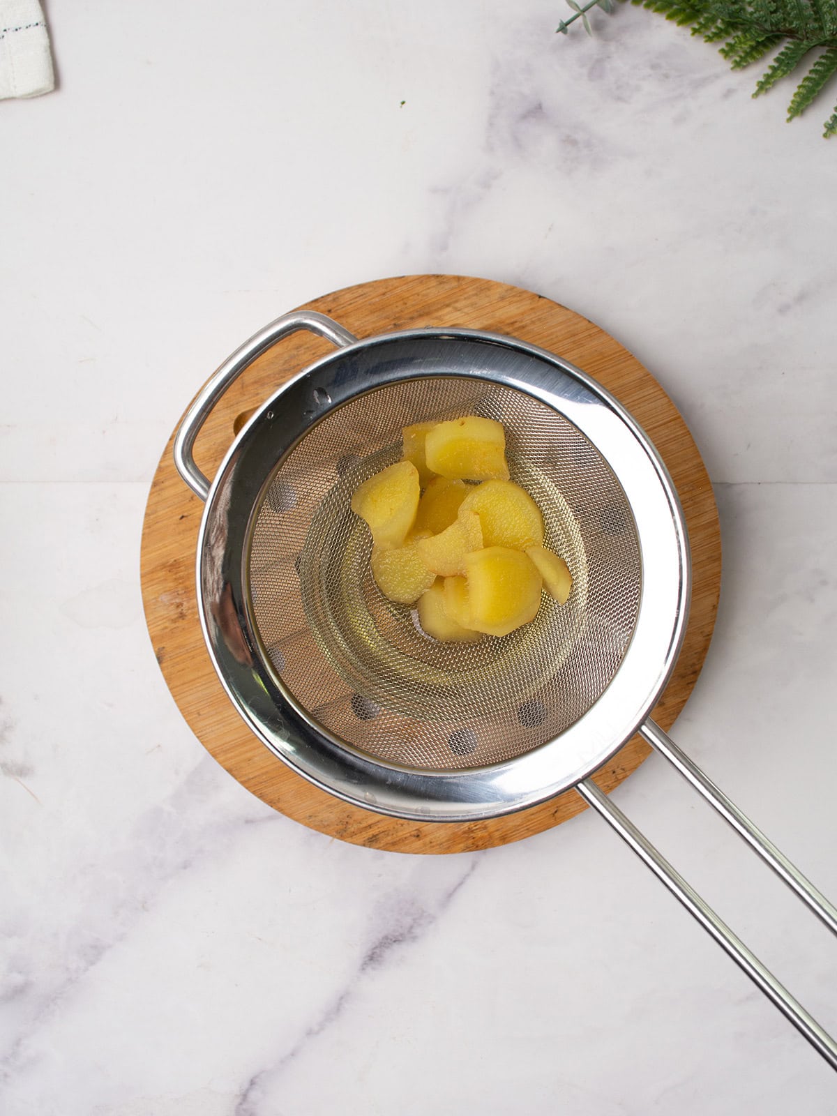 Stirring ginger lemon honey tea with a spoon before serving.