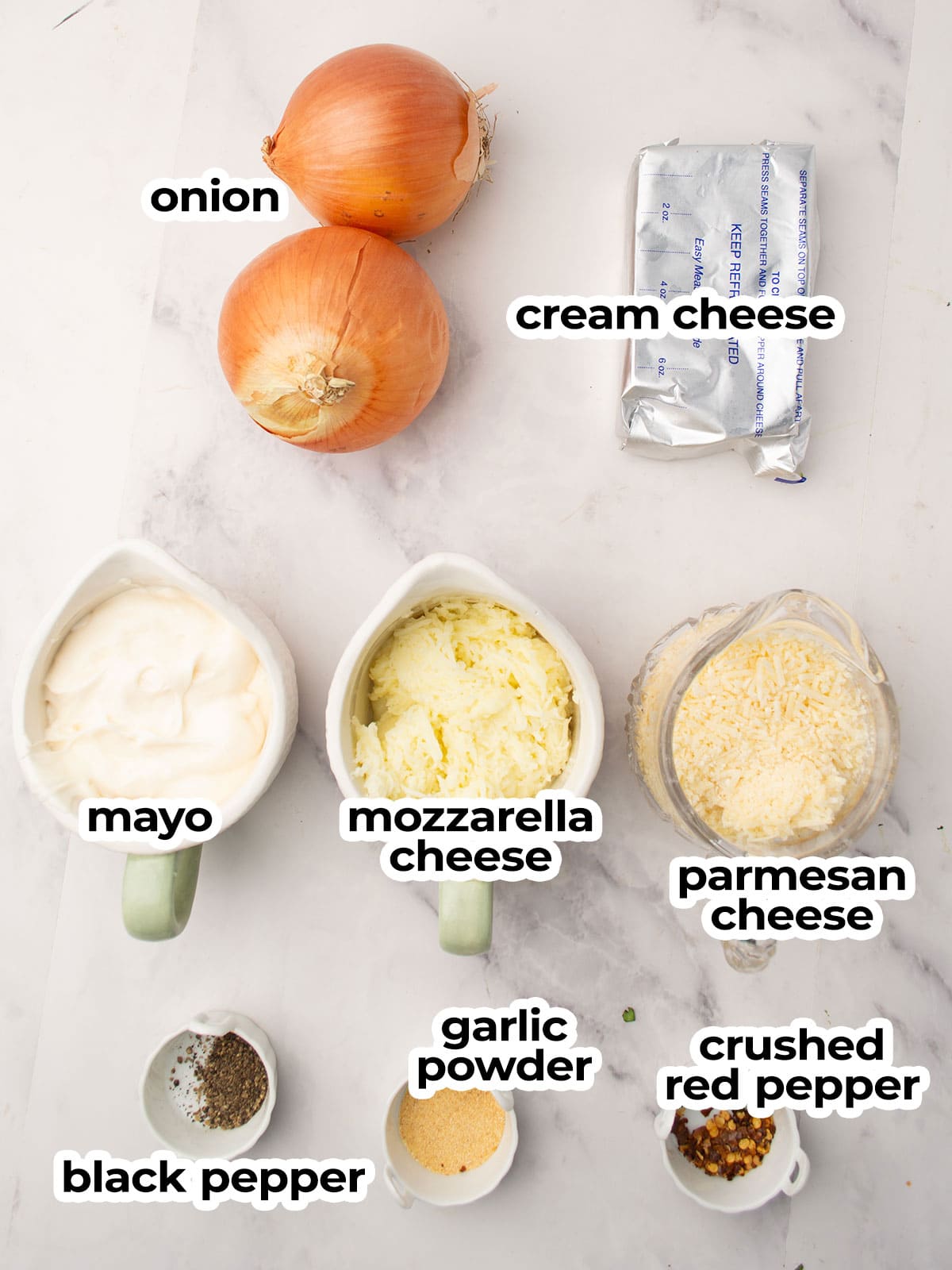 the ingredients for the hot onion dip is placed in the kitchen counter