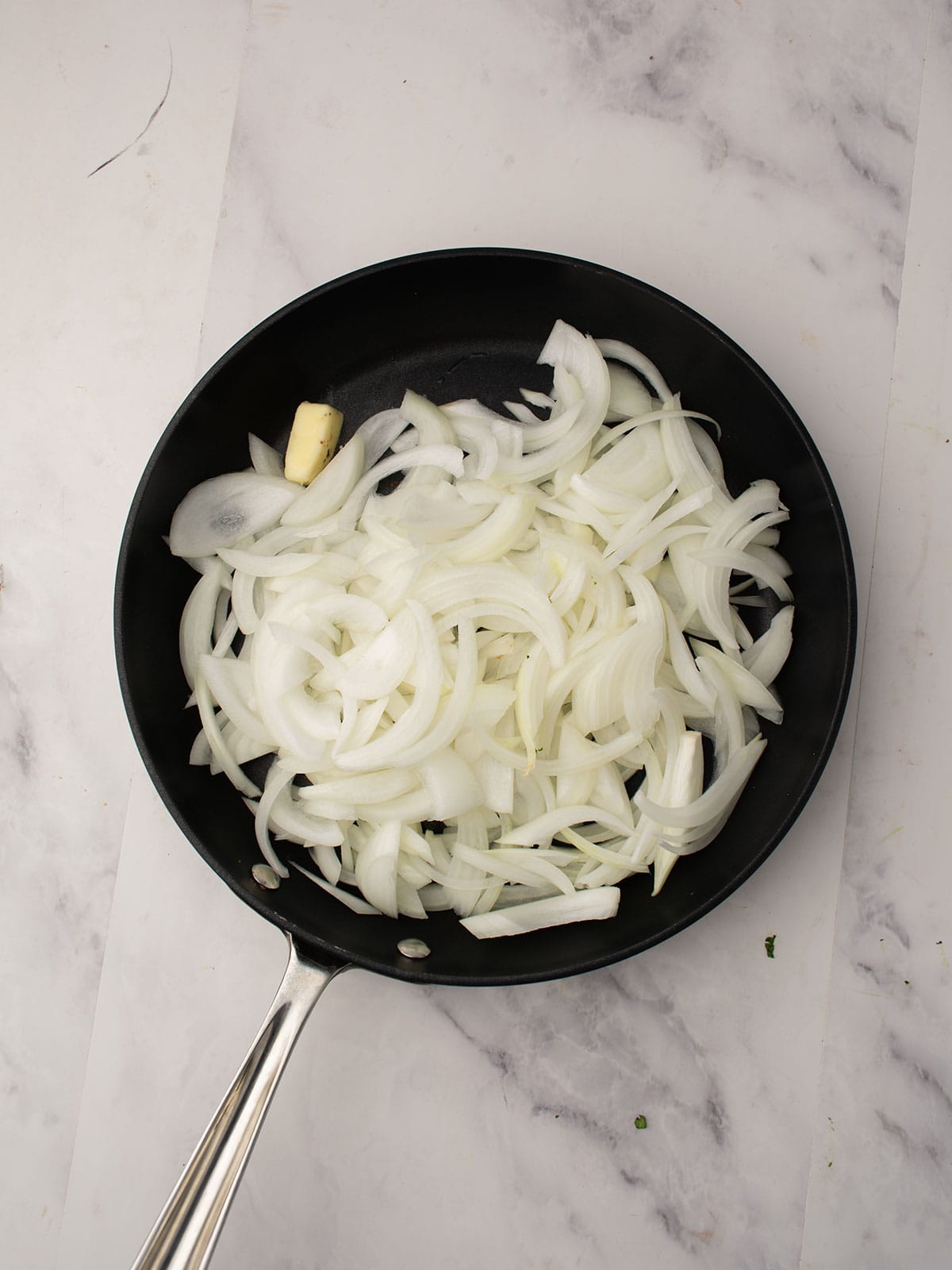 Chopped sweet onions added in a skillet with butter until caramelized.