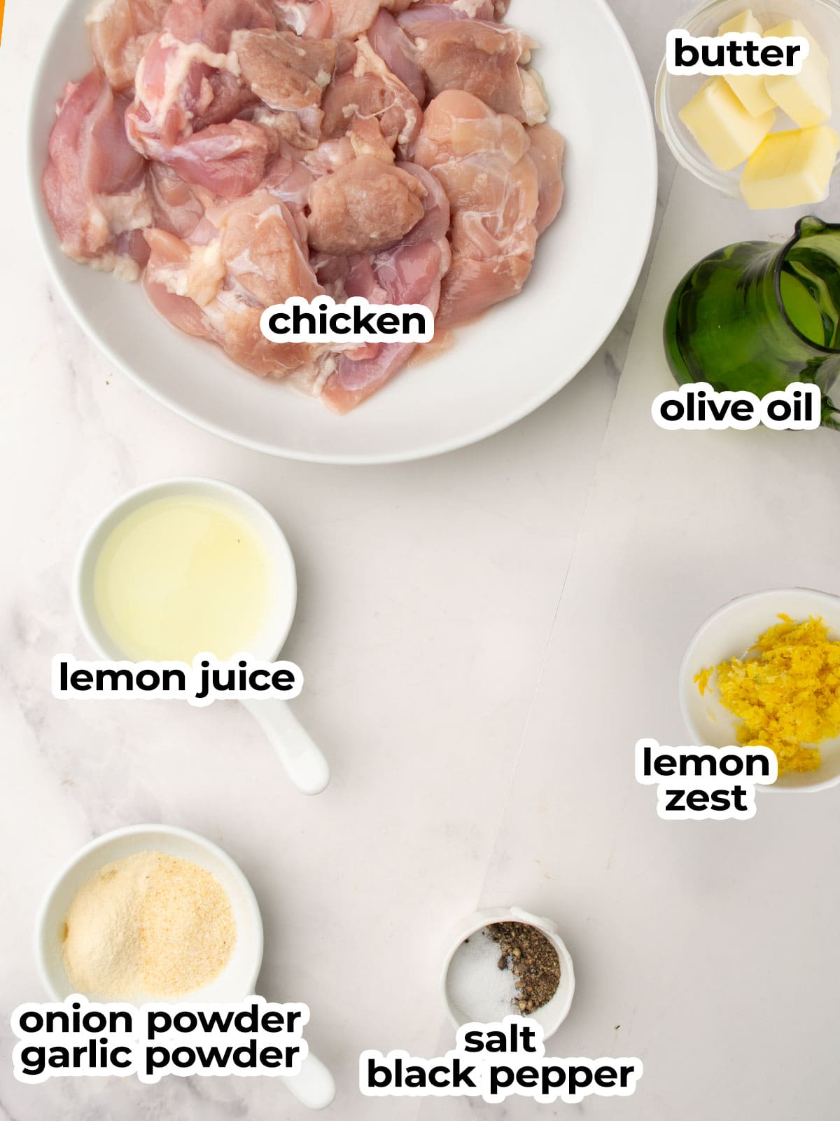 All ingredients for lemon pepper chicken skewers neatly arranged on a wooden background.