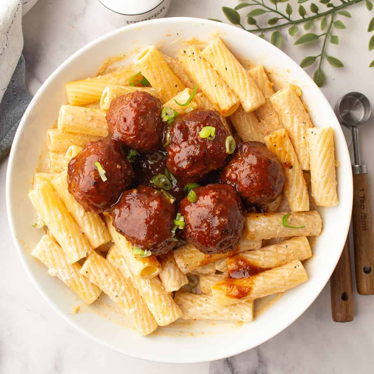 pineapple barbeque meatballs served in over pasta for the weeknight dinner