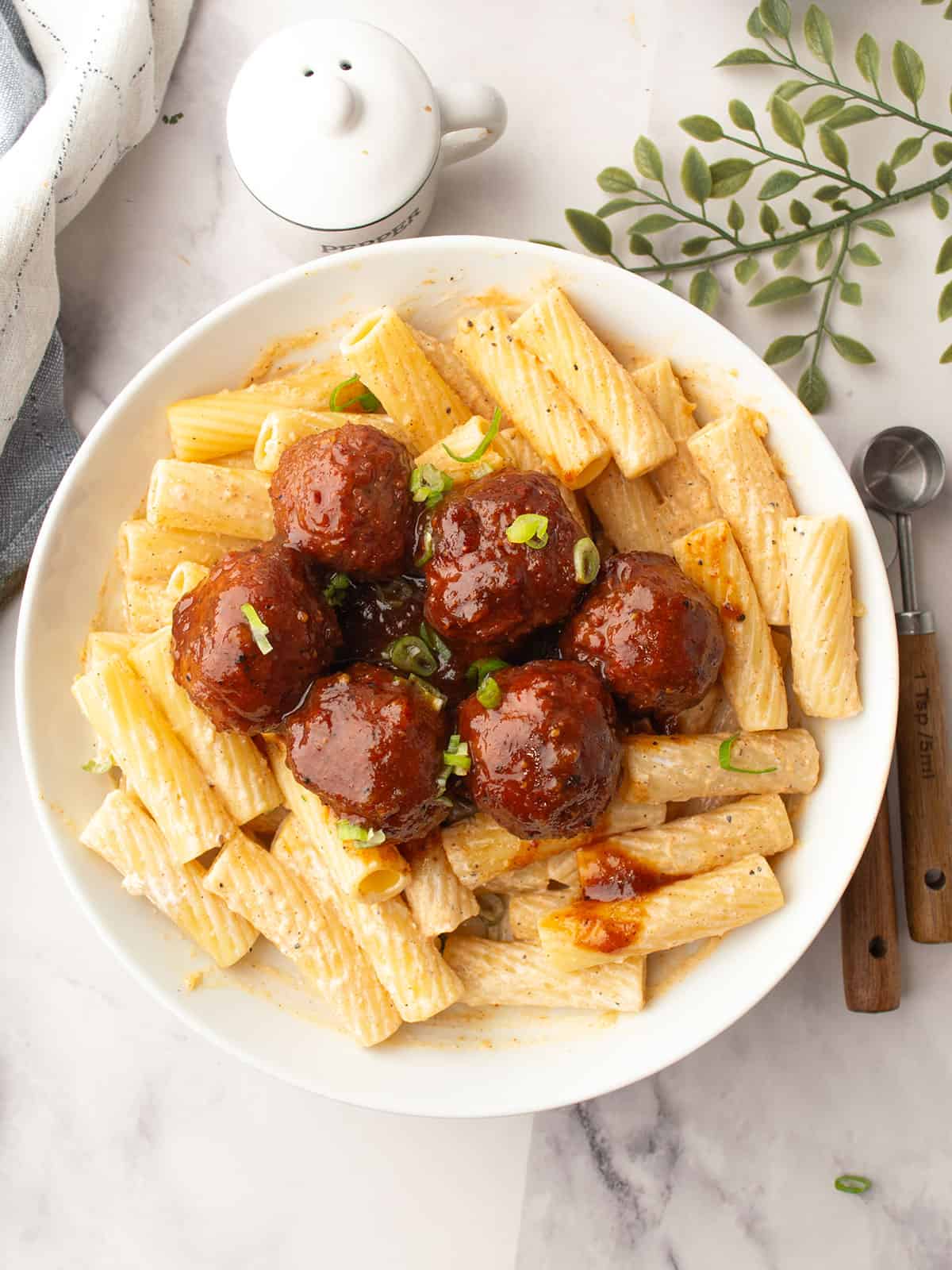 Pineapple barbecue meatballs served in a bowl with glossy sauce.