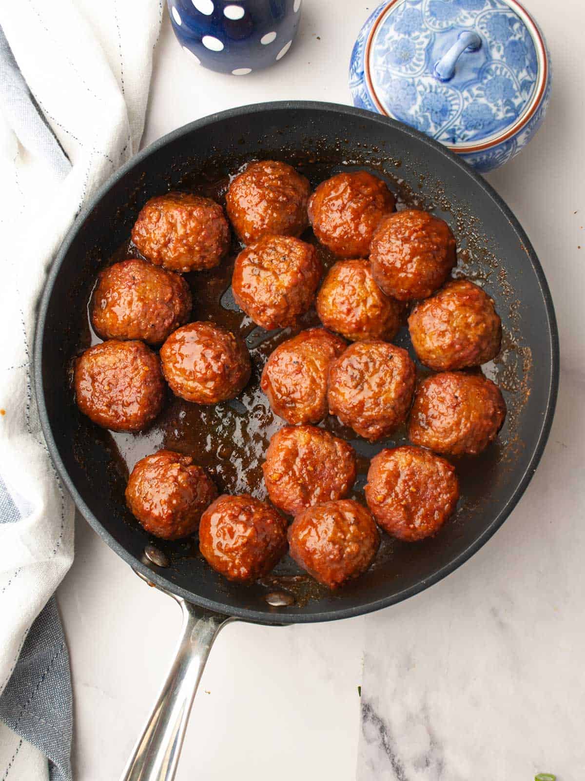 Adding frozen meatballs to the pineapple barbecue sauce mixture.
