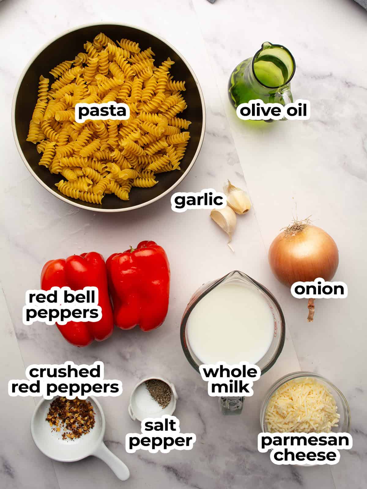 Fresh ingredients for creamy red pepper pasta, including red peppers, garlic, and Parmesan cheese.